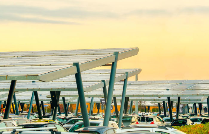 Solar panel canopies covering a large surface parking lot.