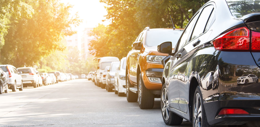 On-street parking on both sides of a busy residential street.