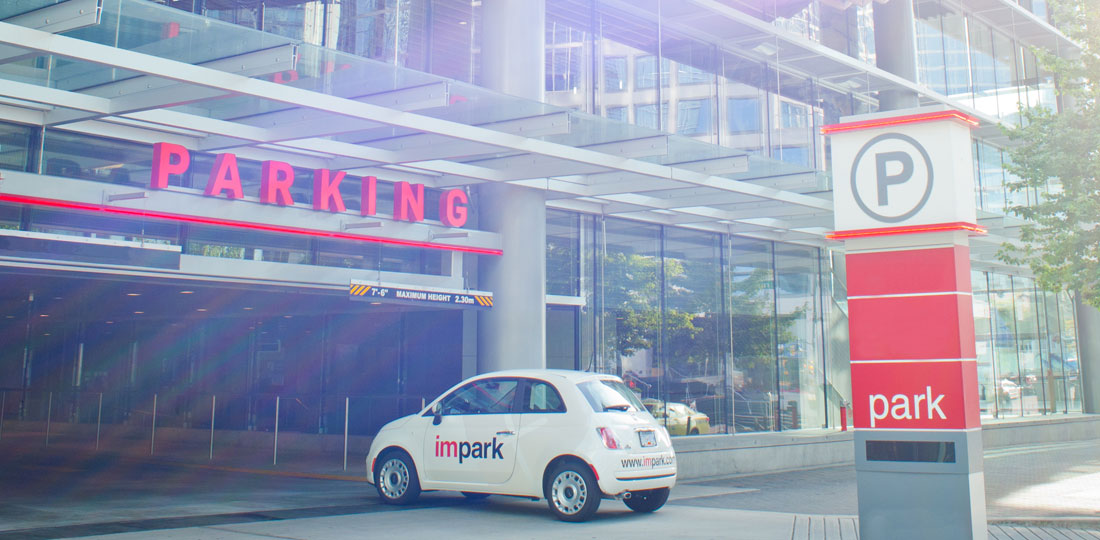 An Impark-branded Fiat 500 entering a well-kept, Impark-managed parking facility.