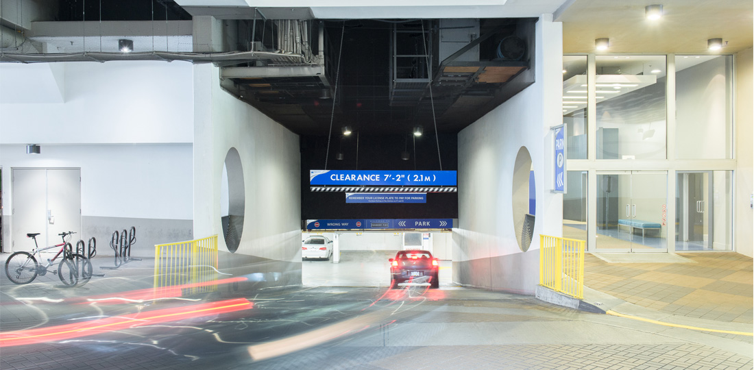 A car enters a gateless underground parking facility.